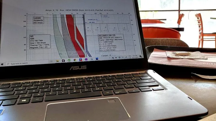 Power System Studies 1 Protection coordination curves for an LV switchboard on a laptop running ETAP during a power system study