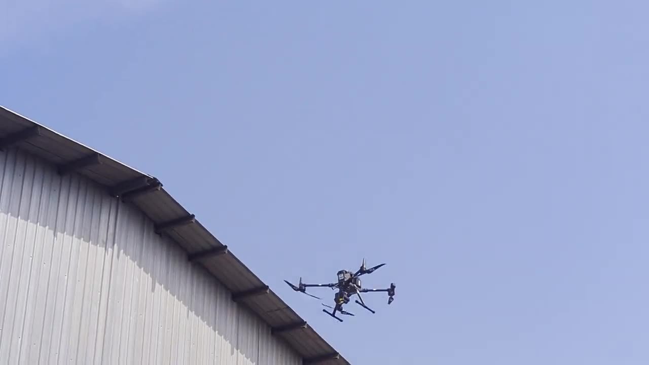 DJI Matrice 350 RTK with thermal payload in flight above an industrial roofline during an aerial inspection in Sri Lanka
