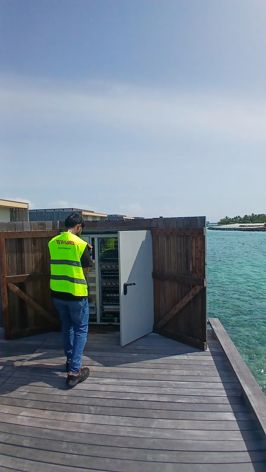 Vibhawa thermographer at a walkway panel above the lagoon at Patina Maldives